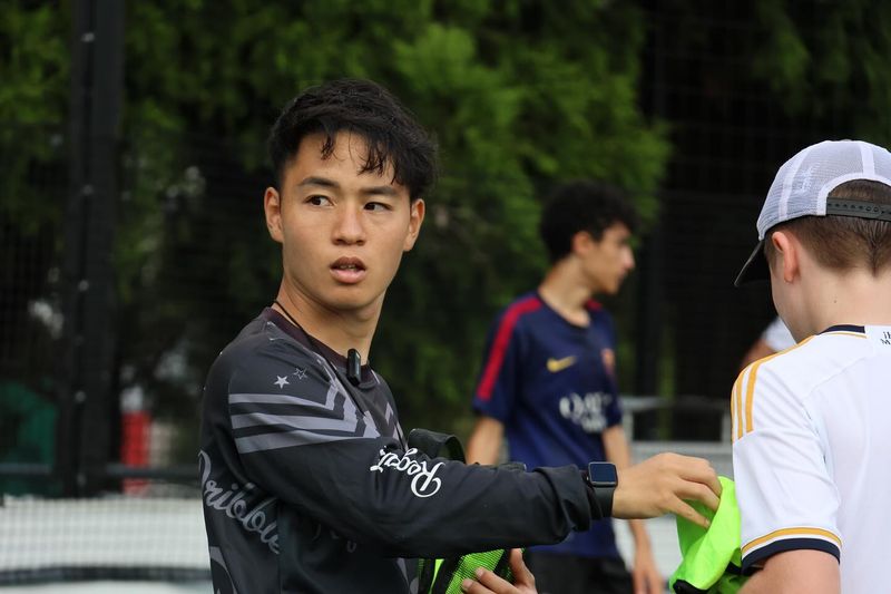 A young player receives one-on-one coaching at Kei Dribble Academy in Sydney, working on ball control with direct instruction and real-time feedback.