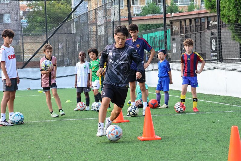 Young players develop essential ball mastery and dribbling skills through structured cone drills at Kei Dribble Academy. This hands-on training builds technical foundation and confidence on the field.