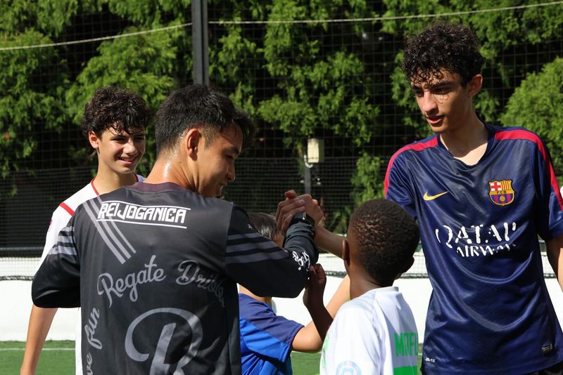 Participants at Kei Dribble Academy engage in an interactive training session focused on developing essential soccer skills. The academy provides expert coaching in ball mastery and dribbling techniques.