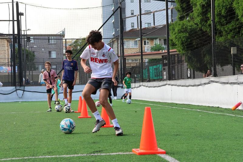 A player works through a cone weave drill at a Kei Dribble Academy training session.