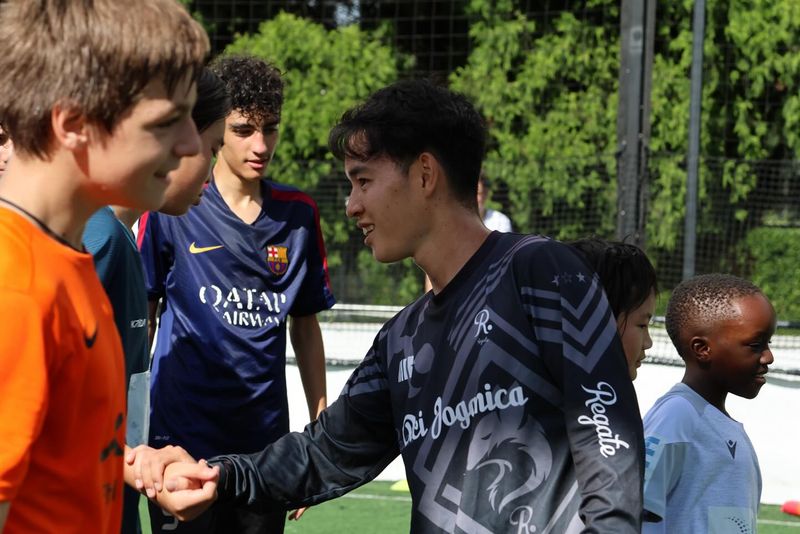 Young players engage in a friendly handshake after a training session at Regate Dribble Academy, focusing on building skills and confidence.