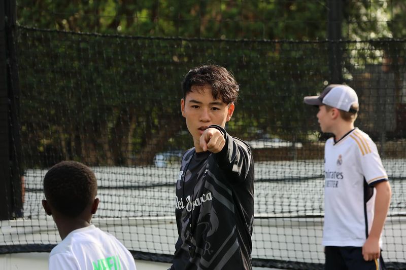 Coach Keishiro gives direction to players during a Kei Dribble Academy training session.
