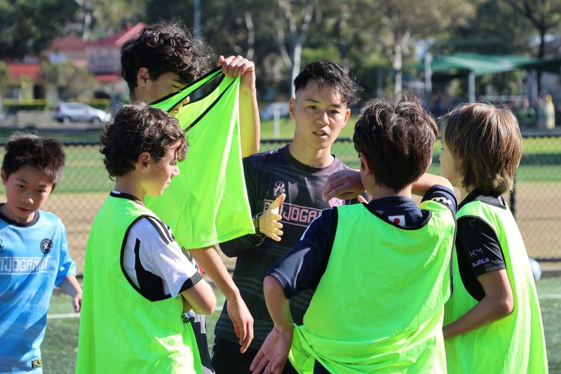 Participants engage in skill-building activities focused on dribbling techniques and game awareness at Kei Dribble Academy in Sydney.